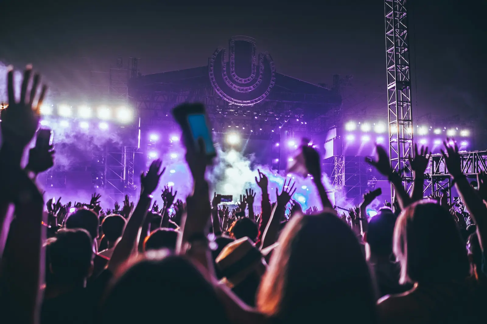 A festival crowd with phones in the air